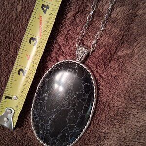 Large black medallion